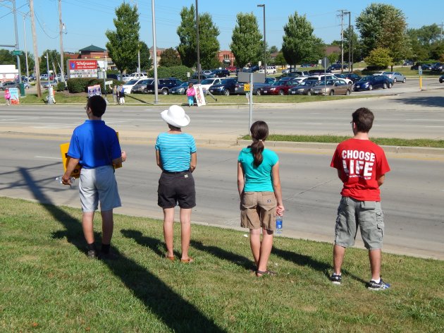 A family protests together along E. New York Street