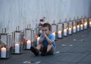Blake Catanese sits near 40 candles at the Flight 93 Memorial Wall
